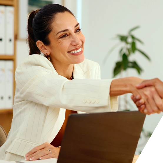 Woman shaking hands across a table